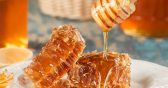 A close up of honey being poured on top of a piece of food.