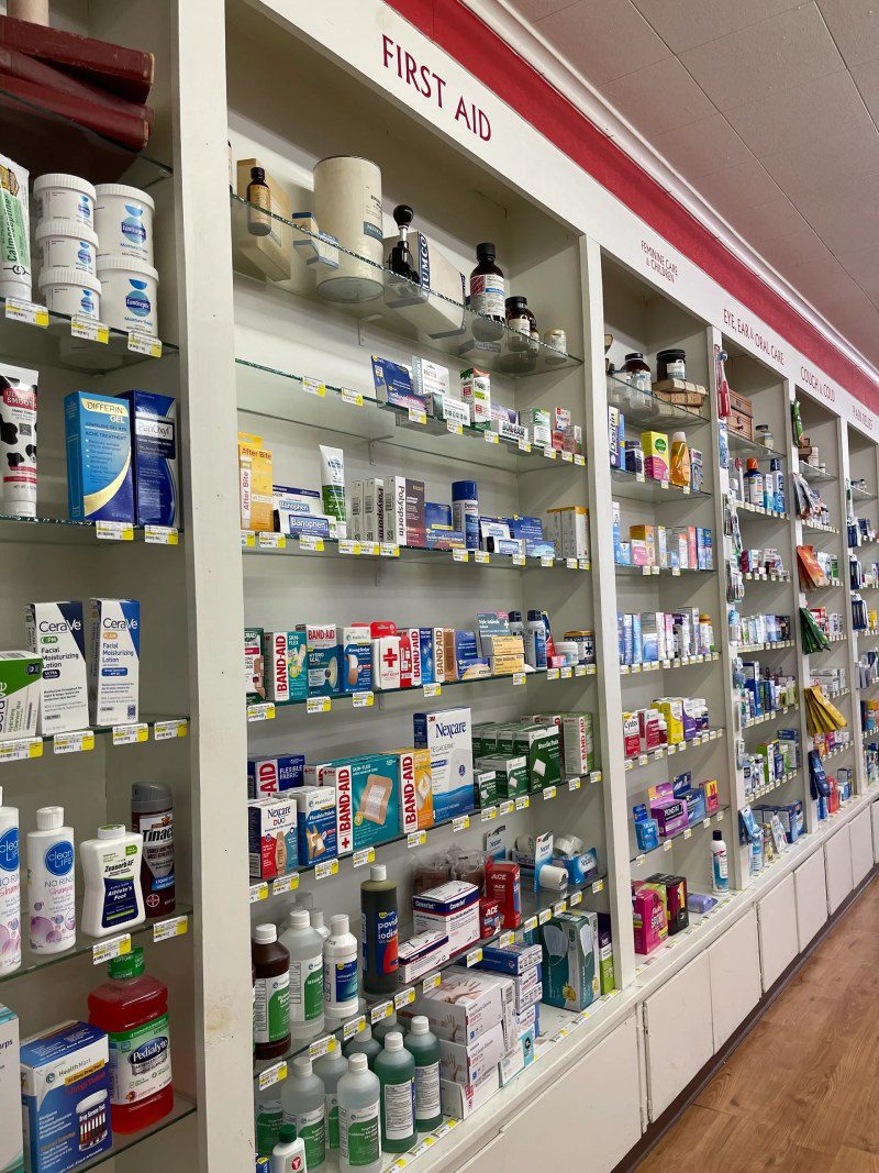 A pharmacy with many shelves of medicine and other items.