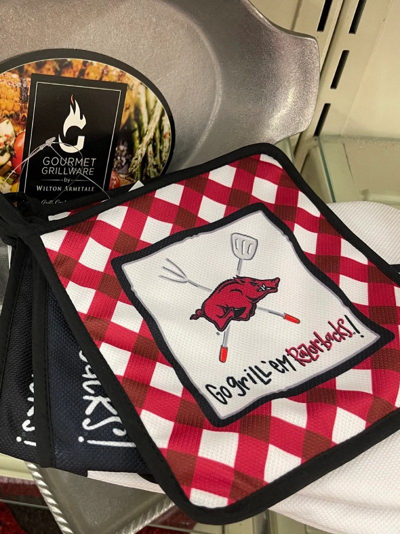 A red and white checkered pot holder with an image of hog.